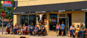 store front of West's Hayward Dairy, families enjoying ice cream on red benches