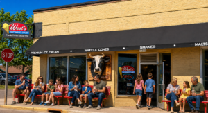 store front of West's Hayward Dairy, families enjoying ice cream on red benches
